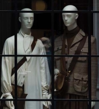 Two mannequins behind a store window